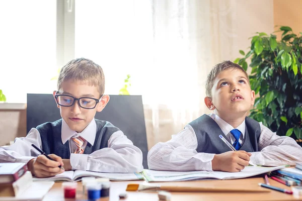 Powrót do szkoły. Słodkie dzieci siedząc przy biurku w klasie. Chłopców jest naukę. Szkoła Podstawowa koncepcja — Zdjęcie stockowe