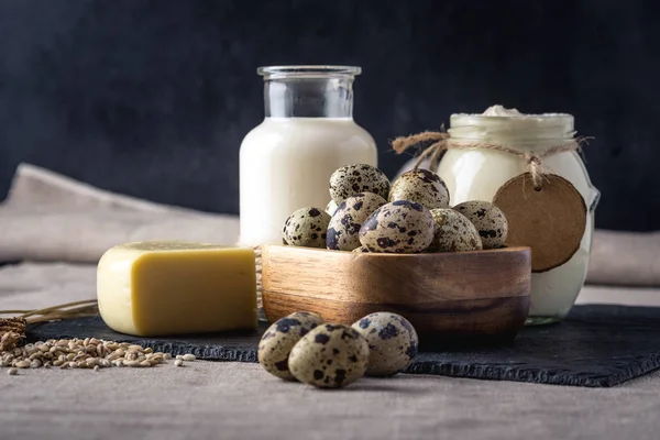 Eko çiftlik ürünleri süt, peynir, ekşi krema, yoğurt, koyu ahşap arka plan üzerinde yumurta. Ev yapımı doğal gıda kavramı