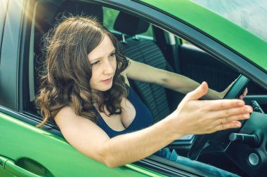 Öfkeli ve sinirli kadın sürücü arabada. Kavga ve tatminsizlik yolda.