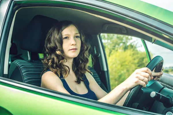 Žena v autě. Ruce na volant. Cílené a napjaté. Lekce v autoškole. — Stock fotografie