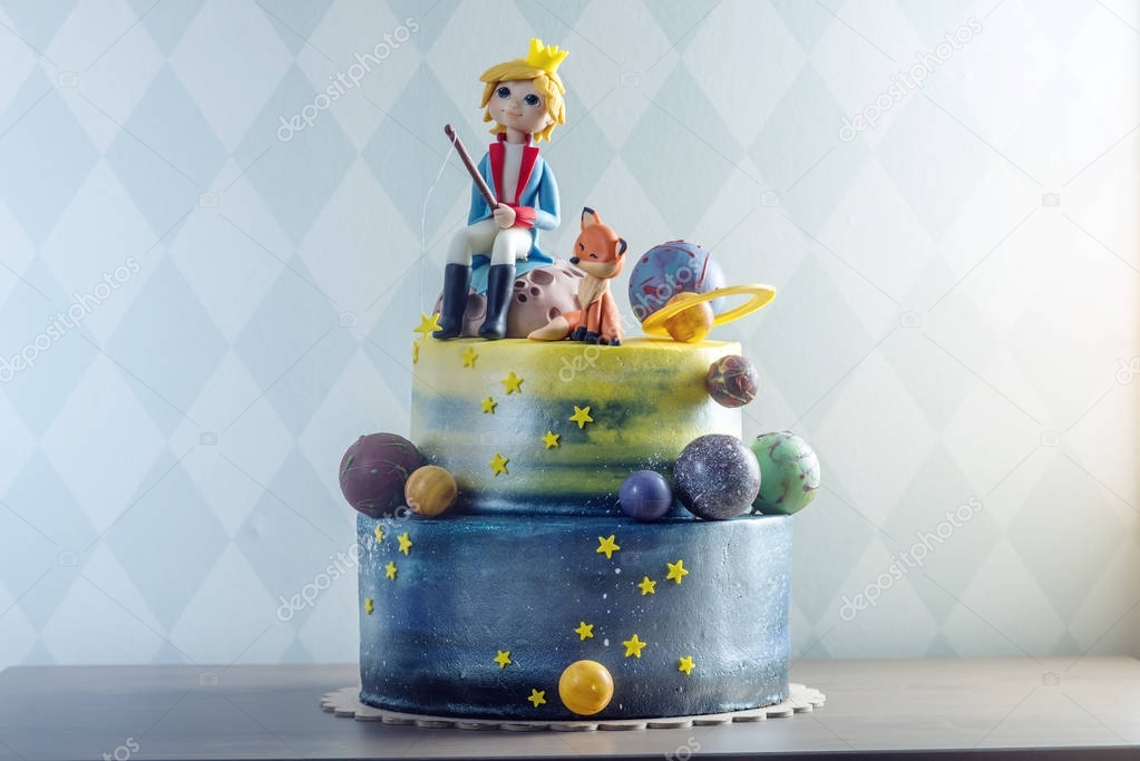 Big kids beautiful cake decorated in the form of the planet with the mastic figurines of the little Prince and the Fox