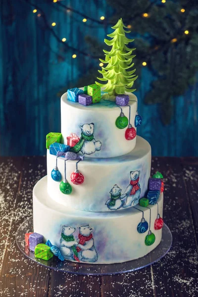 Christmas colorful three-Tiered cake decorated with drawings of Teddy bears, gift boxes and a green tree top — Stock Photo, Image