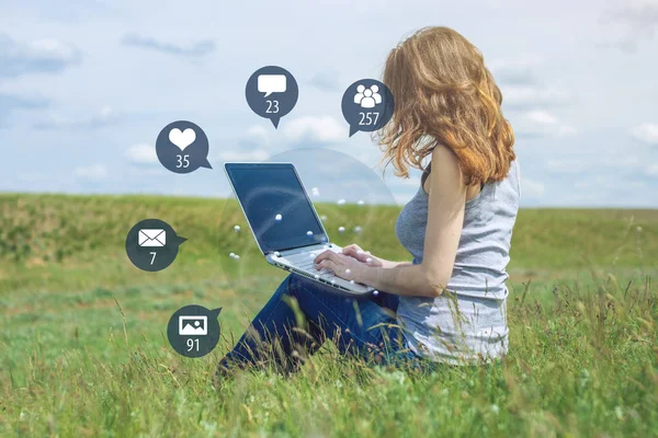 A young woman uses the phone for entertainment and communication on the Internet and viewing notifications in the form of icons. The concept of social network and media