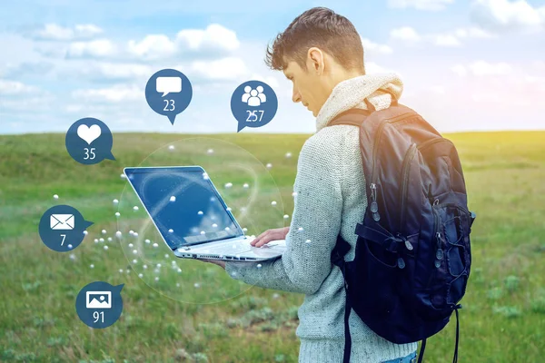 A young man uses the phone for entertainment and communication on the Internet and viewing notifications in the form of icons. The concept of social network and media