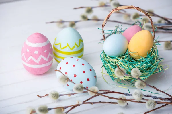 stock image Colorful Easter eggs hand painted on a white wooden background. Festive spring card