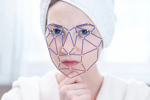 Biometric verification of a modern young woman. New technology of face recognition on polygonal grid