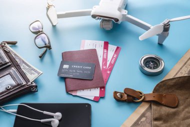 Things for the flight on holiday. Air tickets, passport, phone, credit card, money, drone quadcopter, camera, world map