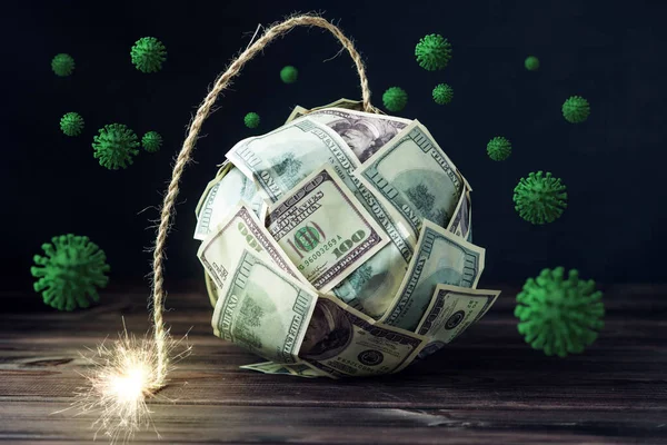 Money in the form of a dollar bomb with a burning fuse due to the COVID-19 coronavirus pandemic. Concept financial crisis 2020