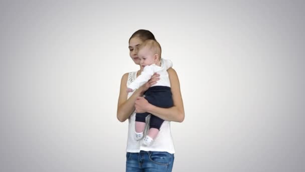 Young mother making an attention gesture while holding her baby, Alpha Channel — Stock Video