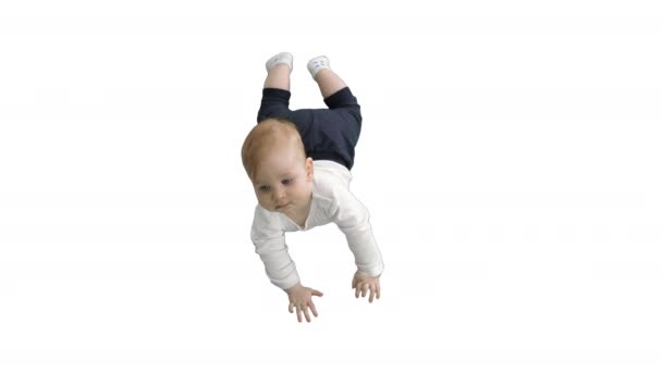 Sweet baby laying and holding his head on white background. — Stock Video