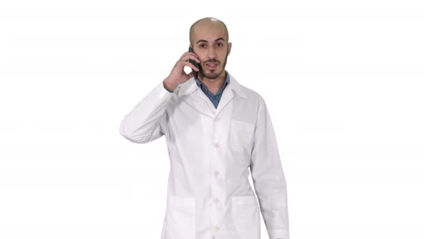 Professional medical doctor talking on mobile phone while walking on white background. — Stock Video