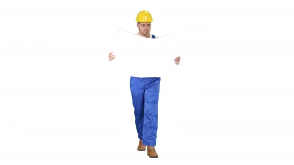 Thoughtful builder in helmet looking at blueprint and walking on white background. — Stock Video