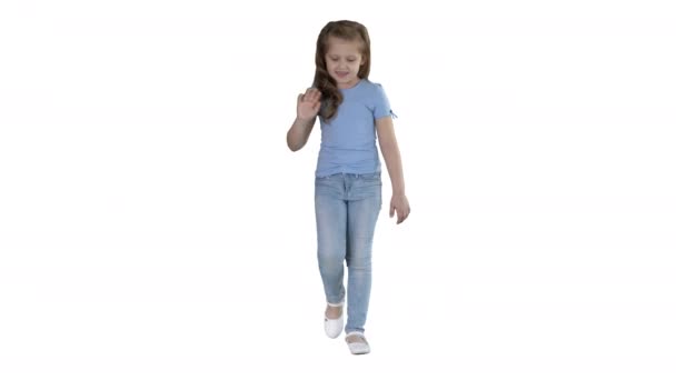 Happy cute little youtuber vlogger waving hand saying hello hi looking at camera talking and walking on white background. — Stockvideo