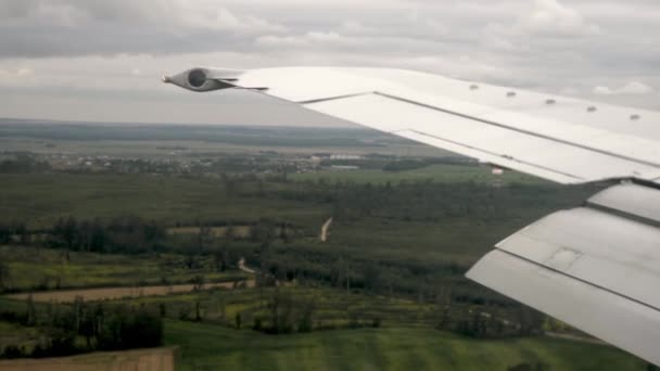 Avión aterrizando. Mira por la ventana del avión durante el vuelo . — Vídeo de stock