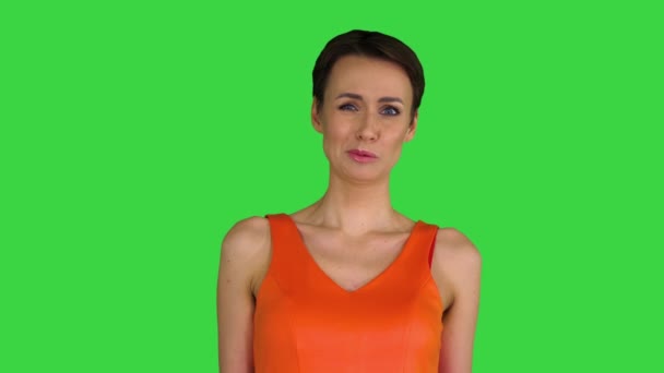 Megdöbbent vagy meglepett fiatal nő narancssárga sundress egy zöld képernyőn, Chroma Key. — Stock videók