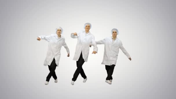 Young men doctors dancing break dance on gradient background. — Stock Video