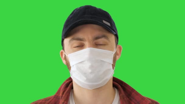 緑の画面、クロマキー上のカメラを探して保護医療マスクを身に着けているアメリカの農家. — ストック動画