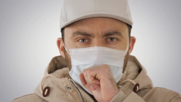 Coughing casual man in medical mask on gradient background. — Stock Video