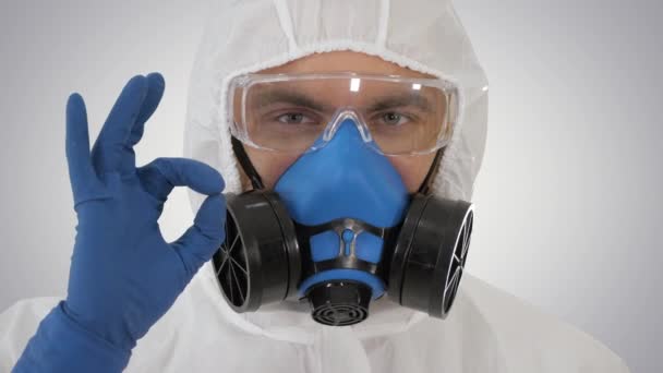 Doctor in protective clothing showing OK Everything will be OK on gradient background. — Stock Video