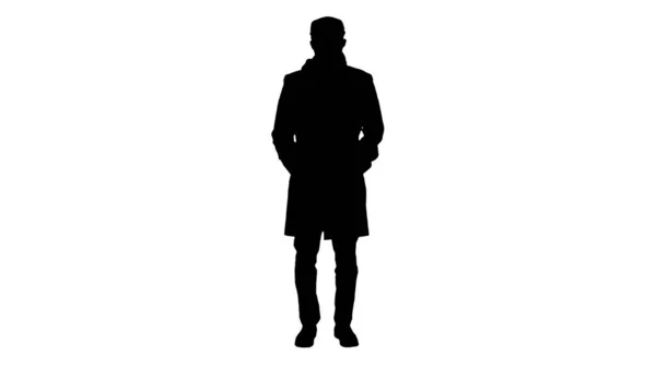Silhouette uomo in stile inglese in un cappotto indossando maschera di protezione l — Foto Stock