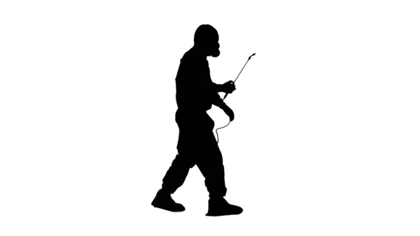 Silhouette Scientist in hazmat suit walking and disinfecting aga — Stock Photo, Image