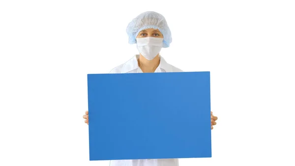 Woman doctor in a mask holding an empty board on white backgroun Royalty Free Stock Images