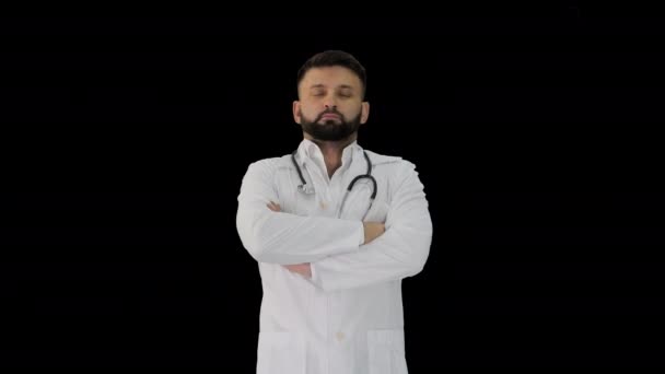 Молодой кавказский врач, стоящий со сложенными руками, канал Альфа — стоковое видео