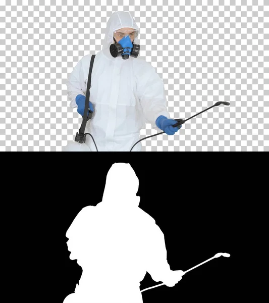 Man in a hazmat walking in and using disinfectant, Alpha Channel