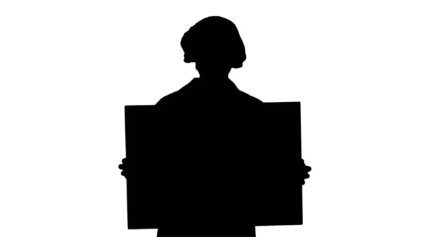 Silhouette Woman doctor in a mask holding an empty board. — Stock Photo, Image