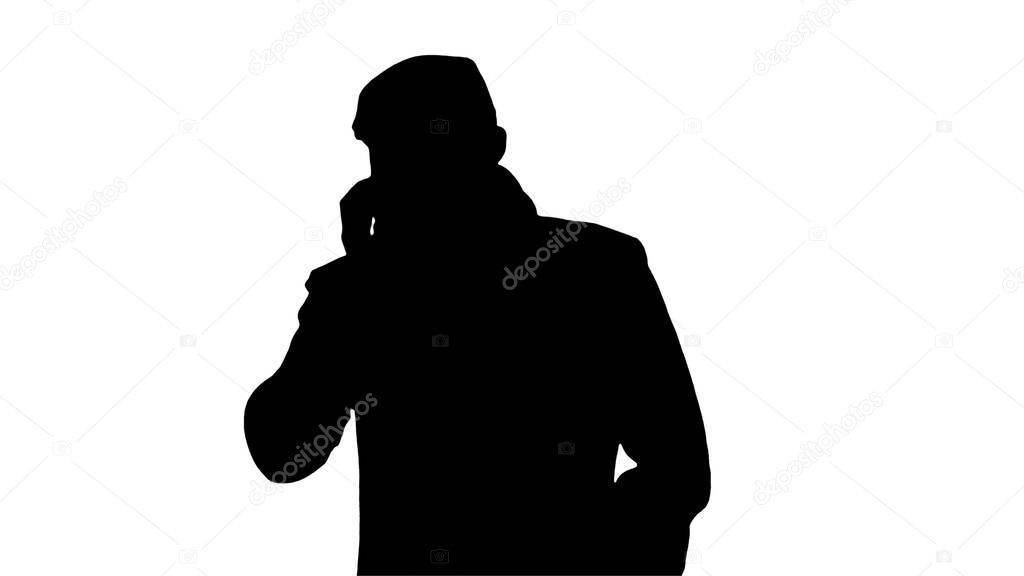 Silhouette Stylish male person with protection mask on walking a