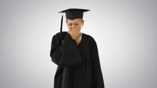 Young graduate girl student in mantle coughing on gradient background. — Stock Video