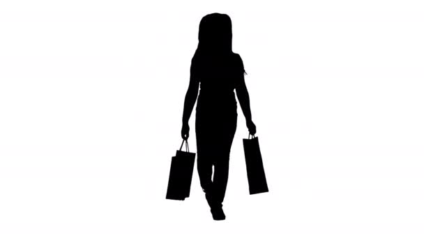 シルエット小さな女の子でショッピングバッグ歩く. — ストック動画