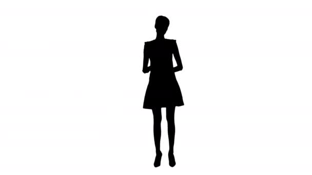 Silhouette Model woman in red dress presenting something showing with a hand on some object. — Stock Video