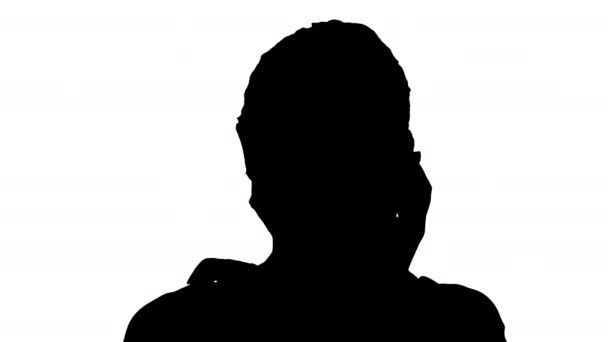 Silhouette Young woman wearing Protective Face Mask making a call walking. — Stock Video