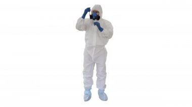 Tehlikeli madde giysisi ve gaz maskeli doktor beyaz arka planda kan tüpü tutuyor..