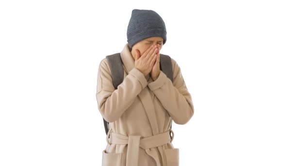 Woman in a coat walking and coughing on white background. — Stock Video