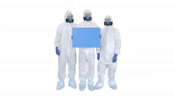 Three doctors in protective suits holding blank board on white background. — Stock Video