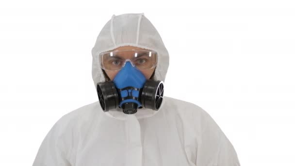 Person wearing a hazmat suit and mask walking on white background. — Stock Video