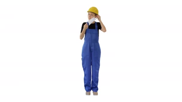 Female construction worker putting on medical mask on white background. — Stock Video