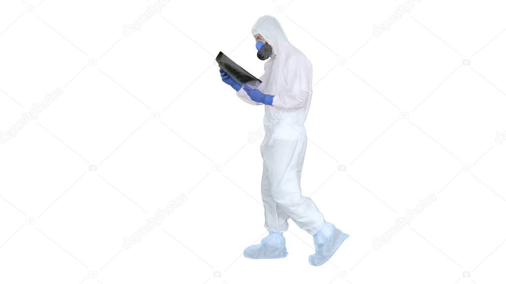 Infectious disease doctor in protective antibacterial suit looking at lungs x-ray on white background.