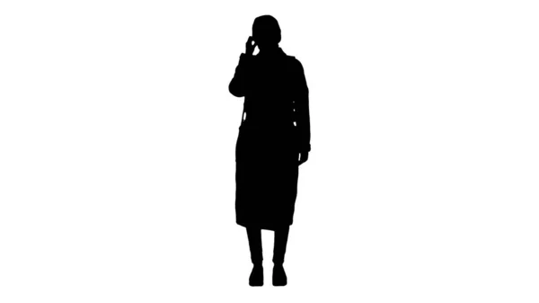 Silhouette Girl in a medical face mask standing in a coat. — Stock Photo, Image
