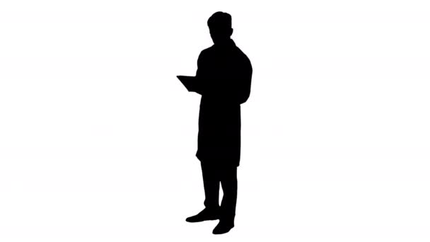 Silhouette Doctor holding digital tablet pc and reading results. — Stock Video