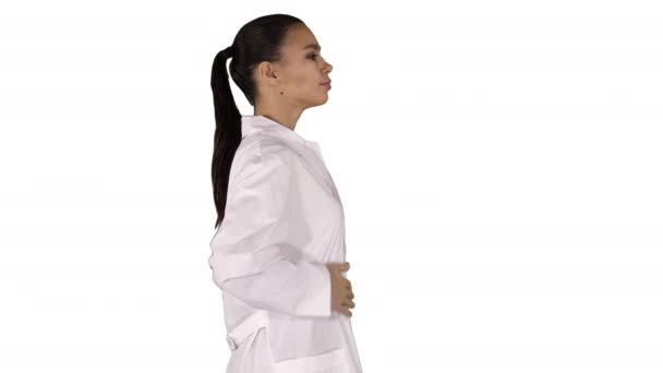 Young woman pharmacist in white gown coat uniform walking on white background. — Stock Video