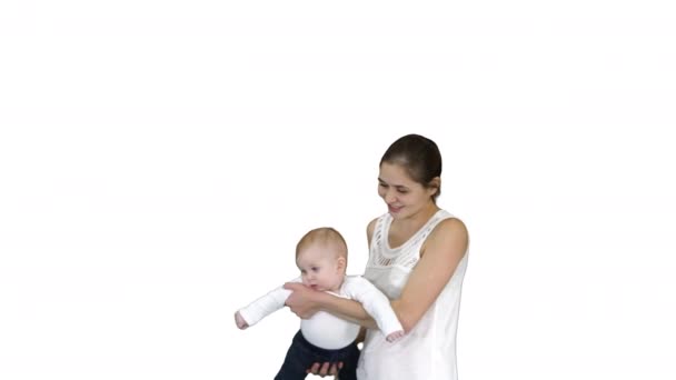 Mãe gira seu bebê em mãos Bebê voando em mãos mães sobre fundo branco . — Vídeo de Stock