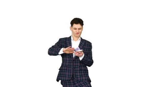 Man in formal suit walking in and throwing money in the air on white background. — Stock Video