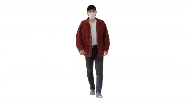 Man in casual shirt and cap walking in medical mask on white background. — Stock Video