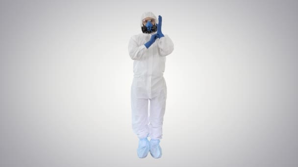 Man Wearing HAZMAT Protective Clothing Showing That He Wears Gloves on gradient background. — Stock Video