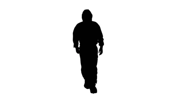 Silhouette Hombre con traje de hazmat caminando . — Foto de Stock