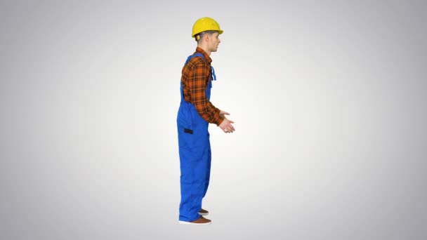 Funky dance by young construction worker in safety hat on gradient background . — стоковое видео