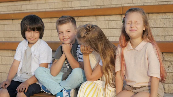 Чотири молоді кавказькі діти сидять і дивляться десь . — стокове фото